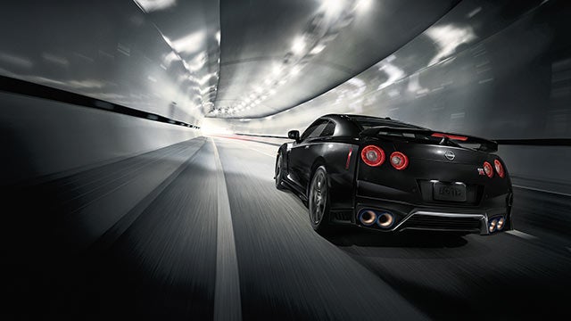 2023 Nissan GT-R seen from behind driving through a tunnel | Rolling Hills Nissan in Saint Joseph MO